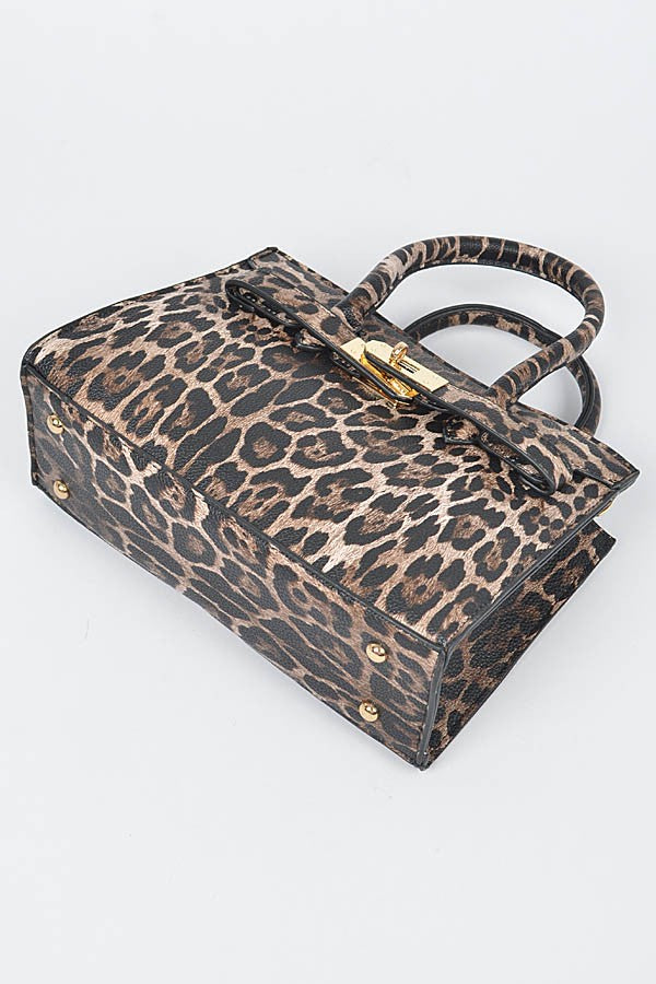 Bottom view of leopard print handbag showing reinforced corners and gold studs.