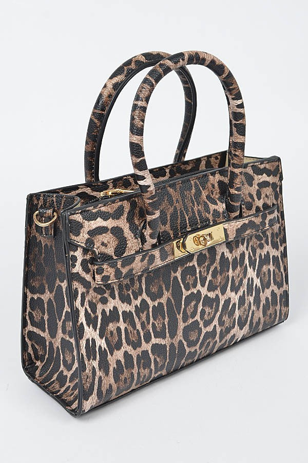 Close-up of leopard print handbag with gold hardware and a structured silhouette.