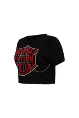 Left side view of black cropped t-shirt showing chain trim detail and red graphic.