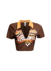 Brown racing-themed graphic shirt with vibrant yellow collar and detailed speed-inspired print on the front.