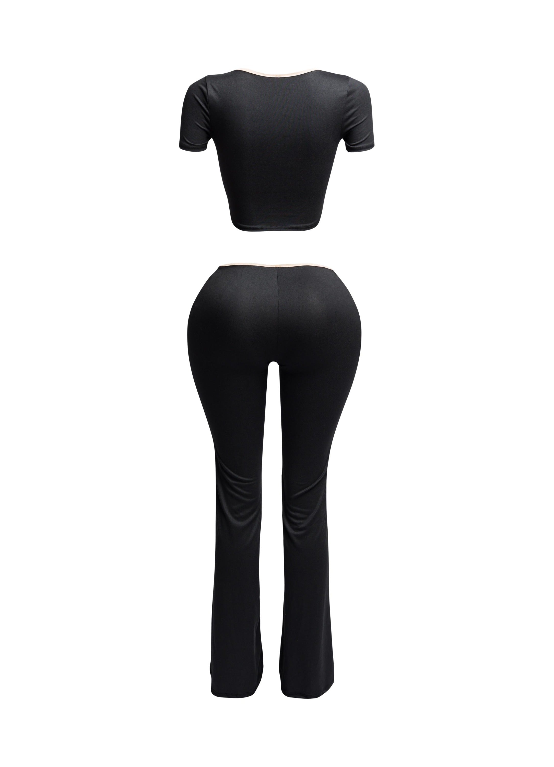 Back view of black two-piece set with nude trim, showing fitted crop top and curve-hugging flared pants.