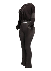 Trendy black lounge set designed with a ribbed finish, featuring a cropped hoodie and flared high-waisted pants. Ideal for a sleek and edgy casual look.