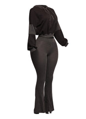 Chic black ribbed lounge set with a cropped hoodie and high-rise flared pants, offering a flattering and trendy silhouette for casual or cozy days.