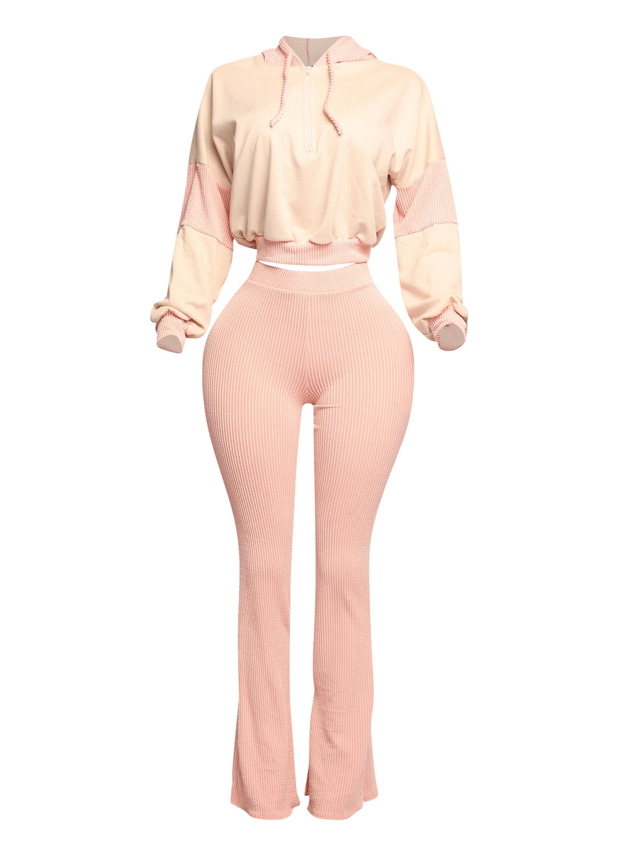 Stylish peach two-piece lounge set with a cropped hoodie and high-waisted flared pants, featuring a ribbed texture for a trendy and flattering fit. Perfect for casual-chic outfits, cozy vibes, and effortless streetwear style.