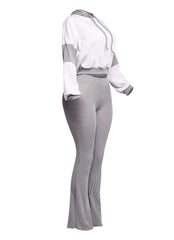 Trendy gray lounge set with a cropped hoodie and high-rise flared pants, crafted in a ribbed texture for a stylish and flattering fit. Ideal for casual and loungewear styling.