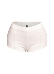 High-waisted micro mini shorts in white with a pintuck detail and elastic waistband, designed for a sleek and flattering fit. Perfect for a trendy and daring casual look.