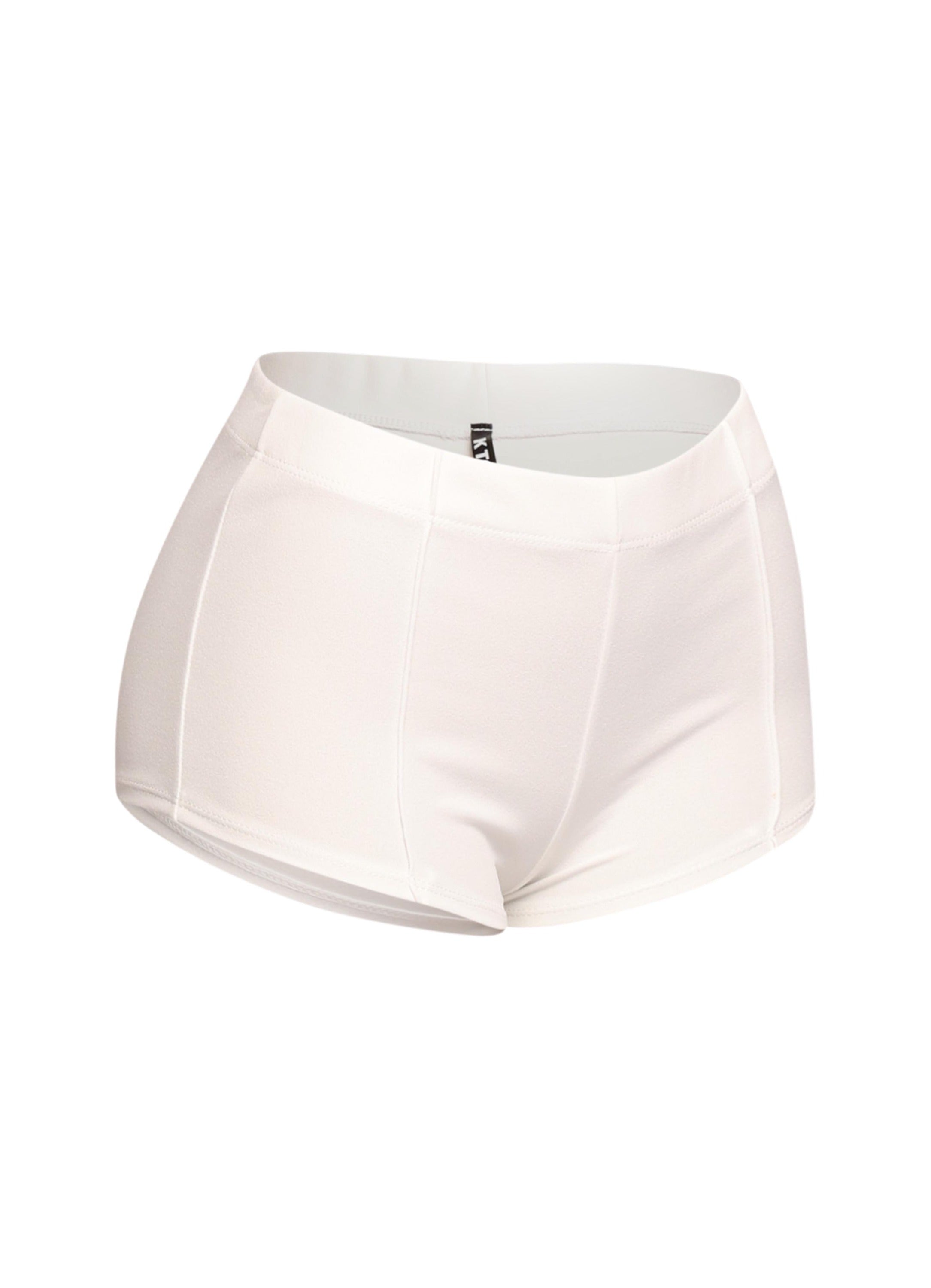 Minimalist white micro shorts with a pintuck finish and comfortable elastic waistband, perfect for modern streetwear or layered statement looks.